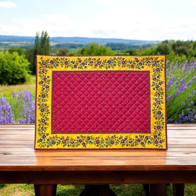 Reversible quilted cotton placemat in Fleurette Red Yellow by Marat d’Avignon, featuring a red diamond-quilted center with petite golden florals and yellow floral scroll borders on the front, and an allover red reverse with golden diamond accents, crafted in Provence.
