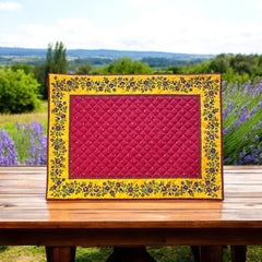 Reversible quilted cotton placemat in Fleurette Red Yellow by Marat d’Avignon, featuring a red diamond-quilted center with petite golden florals and yellow floral scroll borders on the front, and an allover red reverse with golden diamond accents, crafted in Provence.