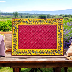 Reversible quilted cotton placemat in Fleurette Red Yellow by Marat d’Avignon, featuring a red diamond-quilted center with petite golden florals and yellow floral scroll borders on the front, and an allover red reverse with golden diamond accents, crafted in Provence.