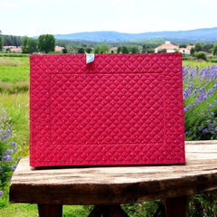 Reversible quilted cotton placemat in Fleurette Red Yellow by Marat d’Avignon, featuring a red diamond-quilted center with petite golden florals and yellow floral scroll borders on the front, and an allover red reverse with golden diamond accents, crafted in Provence.