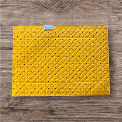Reversible quilted cotton placemat in Fleurette Yellow Red by Marat d’Avignon, featuring a red diamond-quilted center with petite golden florals and yellow floral scroll borders on the front, and an allover red reverse with red floral accents, crafted in Provence.