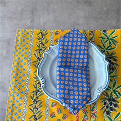 Provence cotton napkins featuring a blue background with light brown floral designs from the Le Cluny Olives Mimosa French Country Collection, made of 100% cotton, measuring 18" x 18", with vibrant, fade-resistant prints.
