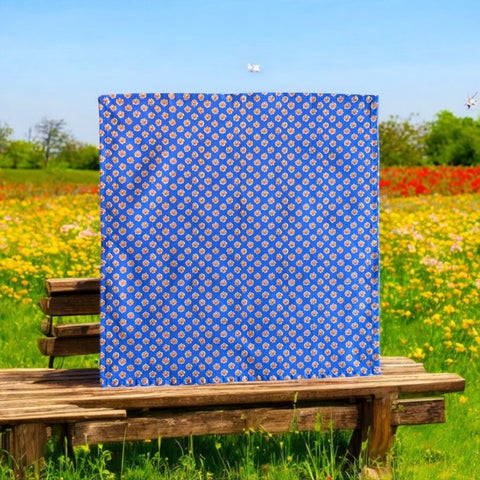 Provence cotton napkins featuring a blue background with light brown floral designs from the Le Cluny Olives Mimosa French Country Collection, made of 100% cotton, measuring 18" x 18", with vibrant, fade-resistant prints.
