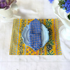 Provence cotton napkins featuring a blue background with light brown floral designs from the Le Cluny Olives Mimosa French Country Collection, made of 100% cotton, measuring 18" x 18", with vibrant, fade-resistant prints.