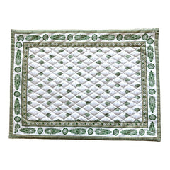 Reversible quilted cotton placemat in Bastide Green by Marat d’Avignon, featuring an ivory background with green floral medallions and scrolling vine borders on the front, and a white reverse with scattered green floral sprigs, crafted in Provence.