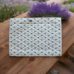 Reversible quilted cotton placemat in Bastide Green by Marat d’Avignon, featuring an ivory background with green floral medallions and scrolling vine borders on the front, and a white reverse with scattered green floral sprigs, crafted in Provence.