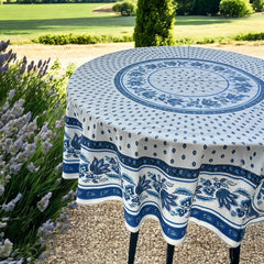 Round Provence-style cotton tablecloth by Le Cluny, featuring a blue and white floral design inspired by French elegance. Coated for easy cleaning, measures 70 inches in diameter, perfect for indoor and outdoor use.