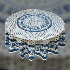 Round Provence-style cotton tablecloth by Le Cluny, featuring a blue and white floral design inspired by French elegance. Coated for easy cleaning, measures 70 inches in diameter, perfect for indoor and outdoor use.