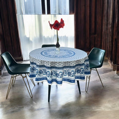 Round Provence-style cotton tablecloth by Le Cluny, featuring a blue and white floral design inspired by French elegance. Coated for easy cleaning, measures 70 inches in diameter, perfect for indoor and outdoor use.