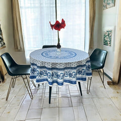 Round Provence-style cotton tablecloth by Le Cluny, featuring a blue and white floral design inspired by French elegance. Coated for easy cleaning, measures 70 inches in diameter, perfect for indoor and outdoor use.