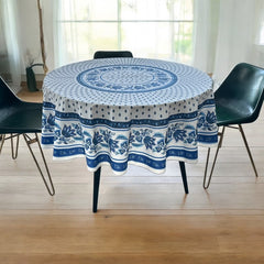 Round Provence-style cotton tablecloth by Le Cluny, featuring a blue and white floral design inspired by French elegance. Coated for easy cleaning, measures 70 inches in diameter, perfect for indoor and outdoor use.