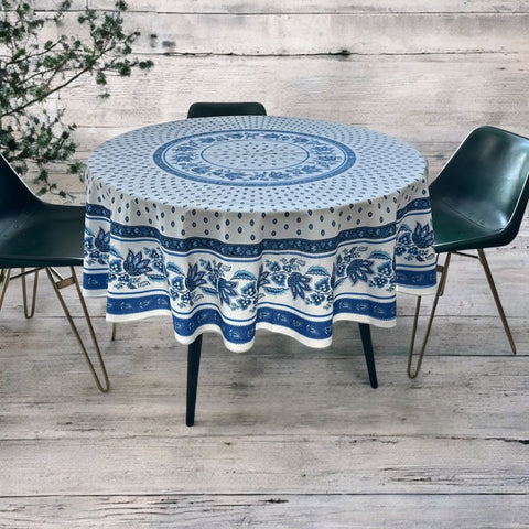 Round Provence-style cotton tablecloth by Le Cluny, featuring a blue and white floral design inspired by French elegance. Coated for easy cleaning, measures 70 inches in diameter, perfect for indoor and outdoor use.