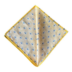 Provence cotton napkins featuring a yellow background with blue and yellow floral designs, part of the Avignon Collection from Marat d’Avignon made of 100% cotton, measuring 18" x 18", with vibrant, fade-resistant prints. Made in France.