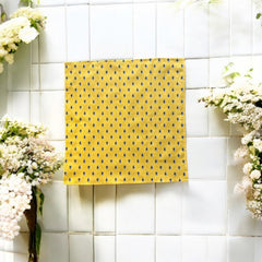 Provence cotton napkins featuring a yellow background with blue and yellow floral designs, part of the Avignon Collection from Marat d’Avignon made of 100% cotton, measuring 18" x 18", with vibrant, fade-resistant prints. Made in France.