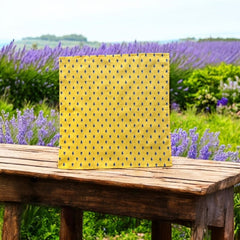 Provence cotton napkins featuring a yellow background with blue and yellow floral designs, part of the Avignon Collection from Marat d’Avignon made of 100% cotton, measuring 18" x 18", with vibrant, fade-resistant prints. Made in France.
