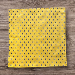 Provence cotton napkins featuring a yellow background with blue and yellow floral designs, part of the Avignon Collection from Marat d’Avignon made of 100% cotton, measuring 18" x 18", with vibrant, fade-resistant prints. Made in France.