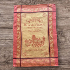 French Provence tea towel featuring the Rosé de Provence Appellation Contrôlée design, showcasing a vineyard and winery in elegant cotton. Available in orange with yellow accents and green with soft purple and gray details. Decorative and eco-friendly kitchen decor.