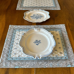 Reversible quilted cotton placemat in Bastide Blue Floral by Marat d’Avignon, featuring a soft blue and grey floral diamond motif on one side and a coordinating striped pattern on the reverse, crafted in Provence.