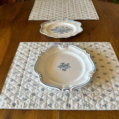 Reversible quilted cotton placemat in Bastide Blue Floral by Marat d’Avignon, featuring a soft blue and grey floral diamond motif on one side and a coordinating striped pattern on the reverse, crafted in Provence.
