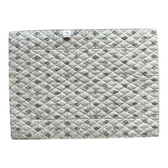 Reversible quilted cotton placemat in Bastide Blue Floral by Marat d’Avignon, featuring a soft blue and grey floral diamond motif on one side and a coordinating striped pattern on the reverse, crafted in Provence.