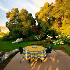 Round Provence-style coated cotton tablecloth by Marat d'Avignon, featuring a vibrant yellow background with blue and white floral patterns. Measures 70 inches in diameter, perfect for indoor and outdoor use, and easy to clean.