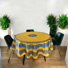 Round Provence-style coated cotton tablecloth by Marat d'Avignon, featuring a vibrant yellow background with blue and white floral patterns. Measures 70 inches in diameter, perfect for indoor and outdoor use, and easy to clean.