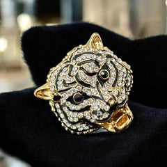 Gold-tone adjustable cocktail ring shaped like a tiger’s head, featuring clear rhinestones and black enamel detailing; ornate design with sparkling facial features and bold statement style, sourced in France and in very good condition.