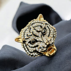 Gold-tone adjustable cocktail ring shaped like a tiger’s head, featuring clear rhinestones and black enamel detailing; ornate design with sparkling facial features and bold statement style, sourced in France and in very good condition.