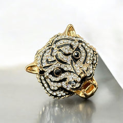 Gold-tone adjustable cocktail ring shaped like a tiger’s head, featuring clear rhinestones and black enamel detailing; ornate design with sparkling facial features and bold statement style, sourced in France and in very good condition.