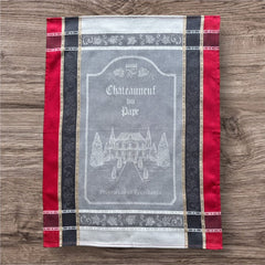 Provence tea towel featuring Châteauneuf-du-Pape winery chateau design with gray background and red and brown striped borders. Made of 100% cotton, ideal for wine-inspired kitchen decor and rustic elegance.