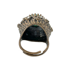 Vintage 1990s Turkish Sultan-style adjustable ring featuring a faceted emerald glass cabochon, clear rhinestones, and ornate antiqued bronze detailing in very good condition.