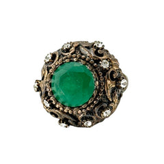 Vintage 1990s Turkish Sultan-style adjustable ring featuring a faceted emerald glass cabochon, clear rhinestones, and ornate antiqued bronze detailing in very good condition.