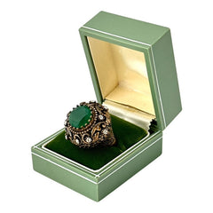 Vintage 1990s Turkish Sultan-style adjustable ring featuring a faceted emerald glass cabochon, clear rhinestones, and ornate antiqued bronze detailing in very good condition.
