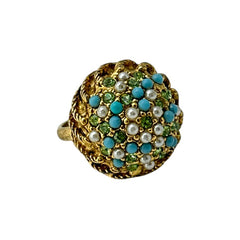 Vintage gold-tone dome cocktail ring featuring faux turquoise, peridot rhinestones, and faux seed pearls with a textured shank. Adjustable on one side and estimated from the 1990s, in good vintage condition.