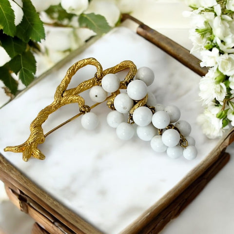 Vintage milk glass brooch featuring three single beads and a grape cluster hanging from textured gold-tone branches, possibly unsigned Marvella from the 1970s/80s, in very good condition with a whimsical and elegant design.