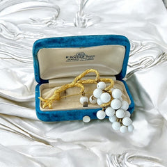 Vintage milk glass brooch featuring three single beads and a grape cluster hanging from textured gold-tone branches, possibly unsigned Marvella from the 1970s/80s, in very good condition with a whimsical and elegant design.