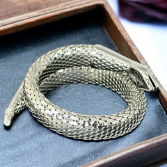 Vintage Whiting & Davis silver-tone mesh snake wrap bracelet with sculpted serpent head and tail, coiled design, adjustable fit, and detailed scale texture—symbolic of transformation and eternity.