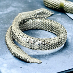 Vintage Whiting & Davis silver-tone mesh snake wrap bracelet with sculpted serpent head and tail, coiled design, adjustable fit, and detailed scale texture—symbolic of transformation and eternity.