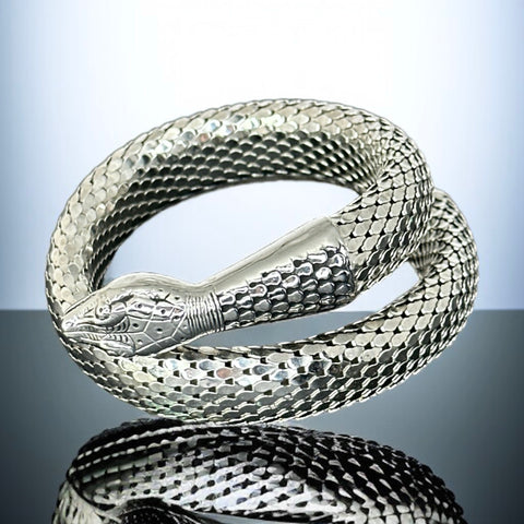 Vintage Whiting & Davis silver-tone mesh snake wrap bracelet with sculpted serpent head and tail, coiled design, adjustable fit, and detailed scale texture—symbolic of transformation and eternity.