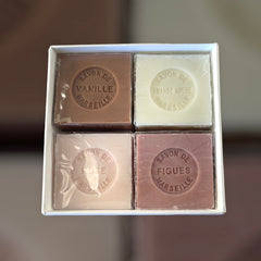 Paris Metro-themed gift box featuring an iconic design, containing four artisanal Marseille cube soaps in Rose, Vanilla, Fig, and Almond fragrances.