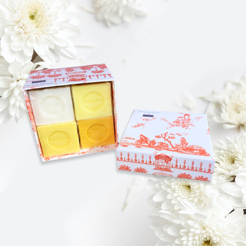 Orange Toile de Jouy gift box with vibrant patterns, containing four artisanal Marseille cube soaps in Honeysuckle, Mimosa, Orange-Grapefruit, and Jasmine fragrances.
