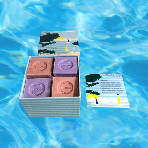 Sea-themed gift box with an elegant design, containing four artisanal Marseille cube soaps: two in Fig fragrance and two in Lavender fragrance.