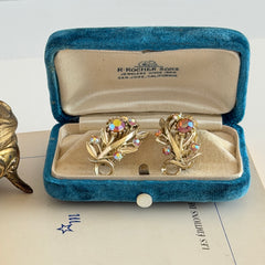 Vintage light gold‑tone floral clip‑on earrings with AB topaz rhinestones in a mid‑century design.