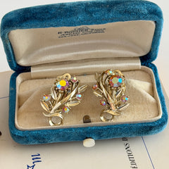 Vintage light gold‑tone floral clip‑on earrings with AB topaz rhinestones in a mid‑century design.