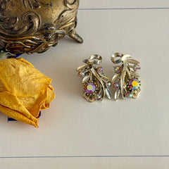 Vintage light gold‑tone floral clip‑on earrings with AB topaz rhinestones in a mid‑century design.