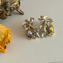 Vintage light gold‑tone floral clip‑on earrings with AB topaz rhinestones in a mid‑century design.