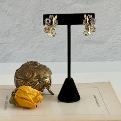 Vintage light gold‑tone floral clip‑on earrings with AB topaz rhinestones in a mid‑century design.