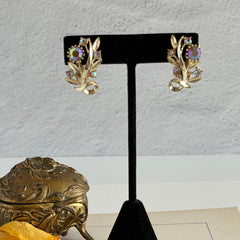 Vintage light gold‑tone floral clip‑on earrings with AB topaz rhinestones in a mid‑century design.
