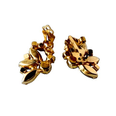 Vintage gold‑tone floral clip‑on earrings with iridescent AB marquise and round rhinestones reflecting rainbow hues.
