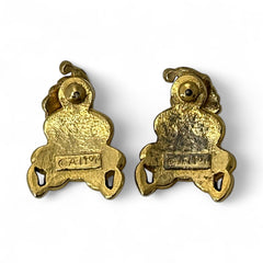 Vintage AIM Santa earrings with red, white, and black enamel, signed with copyright mark, featuring movable head and pierced stud design.